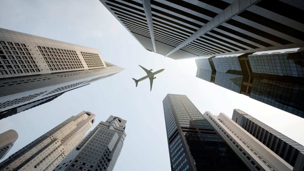 Aeroplane flying over skyscrapers